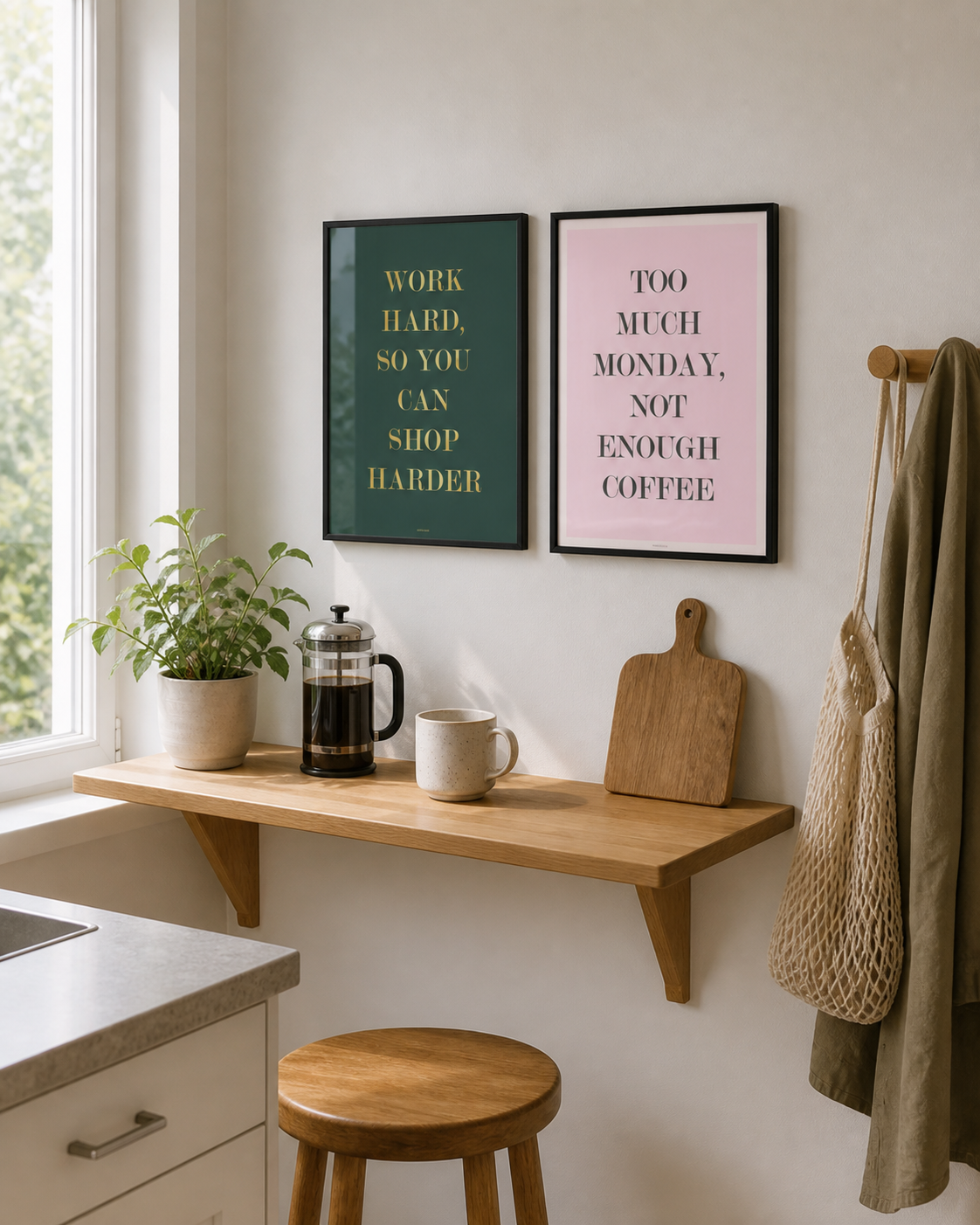 SHOP HARDER og NOT ENOUGH COFFEE plakater i sorte rammer over en lys køkkenhylde med kaffe